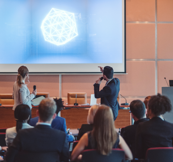 scientists presenting to large group Scientists Presenting To Large Group
